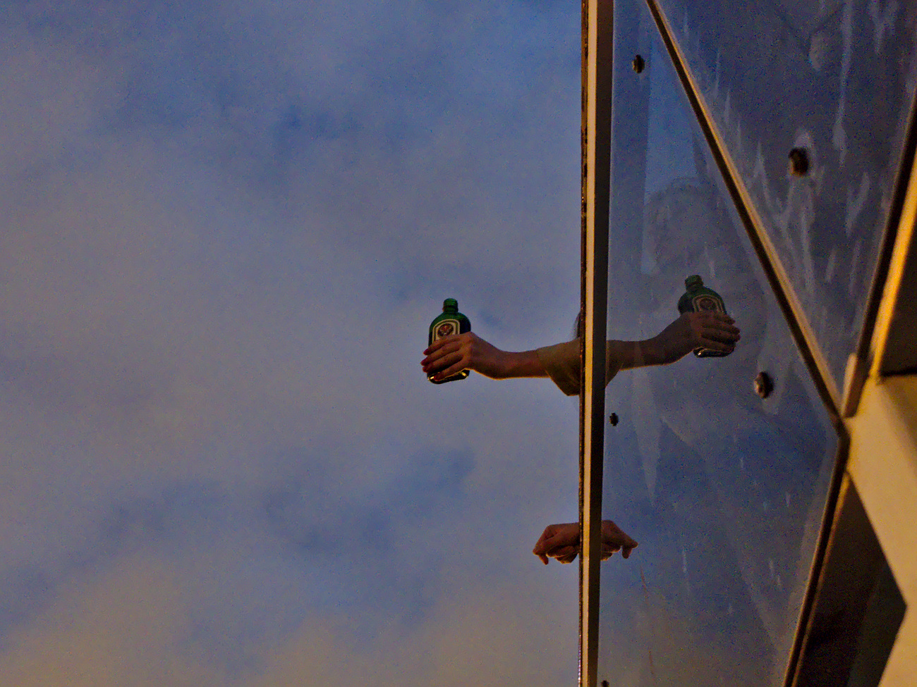 Woman holding a bottle during a boat tour on the Neva river, St. Petersburg, Russia.