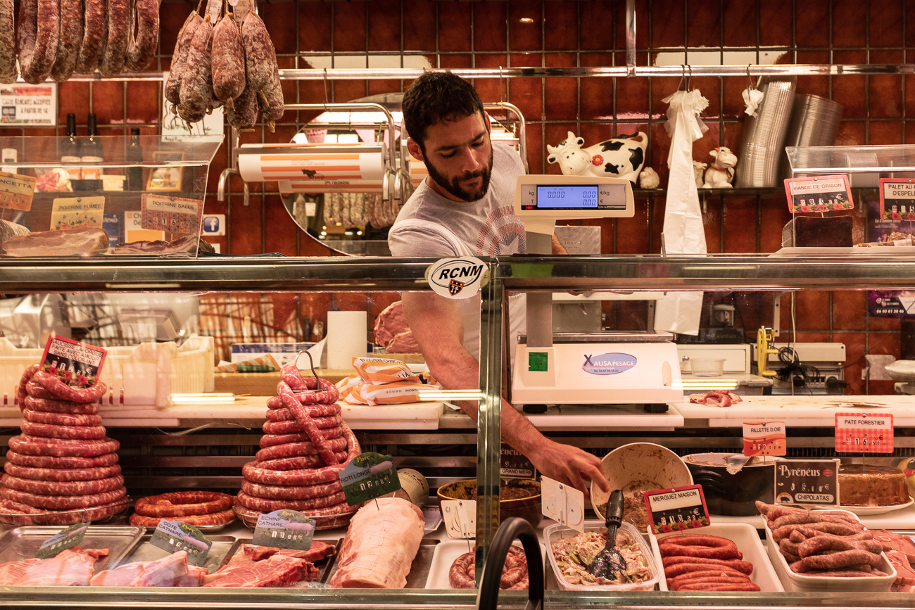 A butcher at the market of Narbonne, France.
