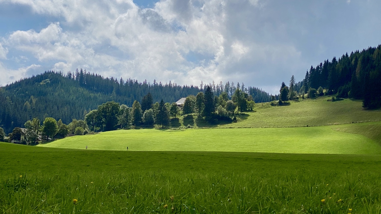 A landscape with mixed sun and clouds near the village of Hart, Austria.